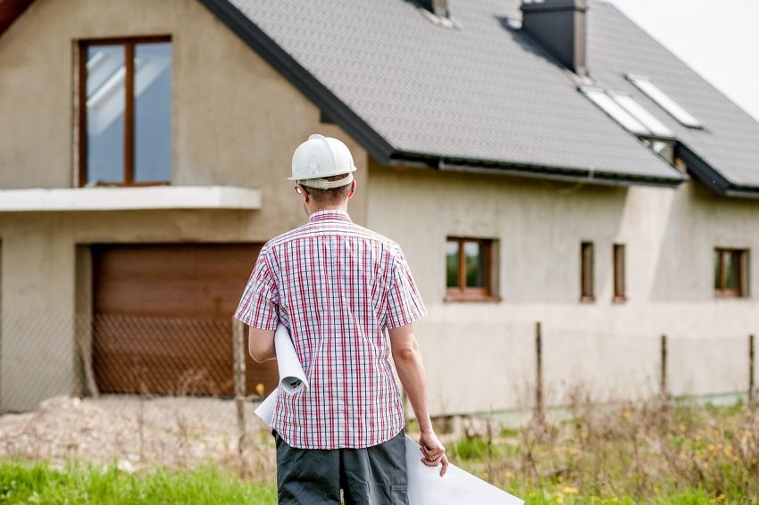 architect walking towards a newly built house