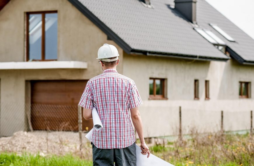 architect walking towards a newly built house