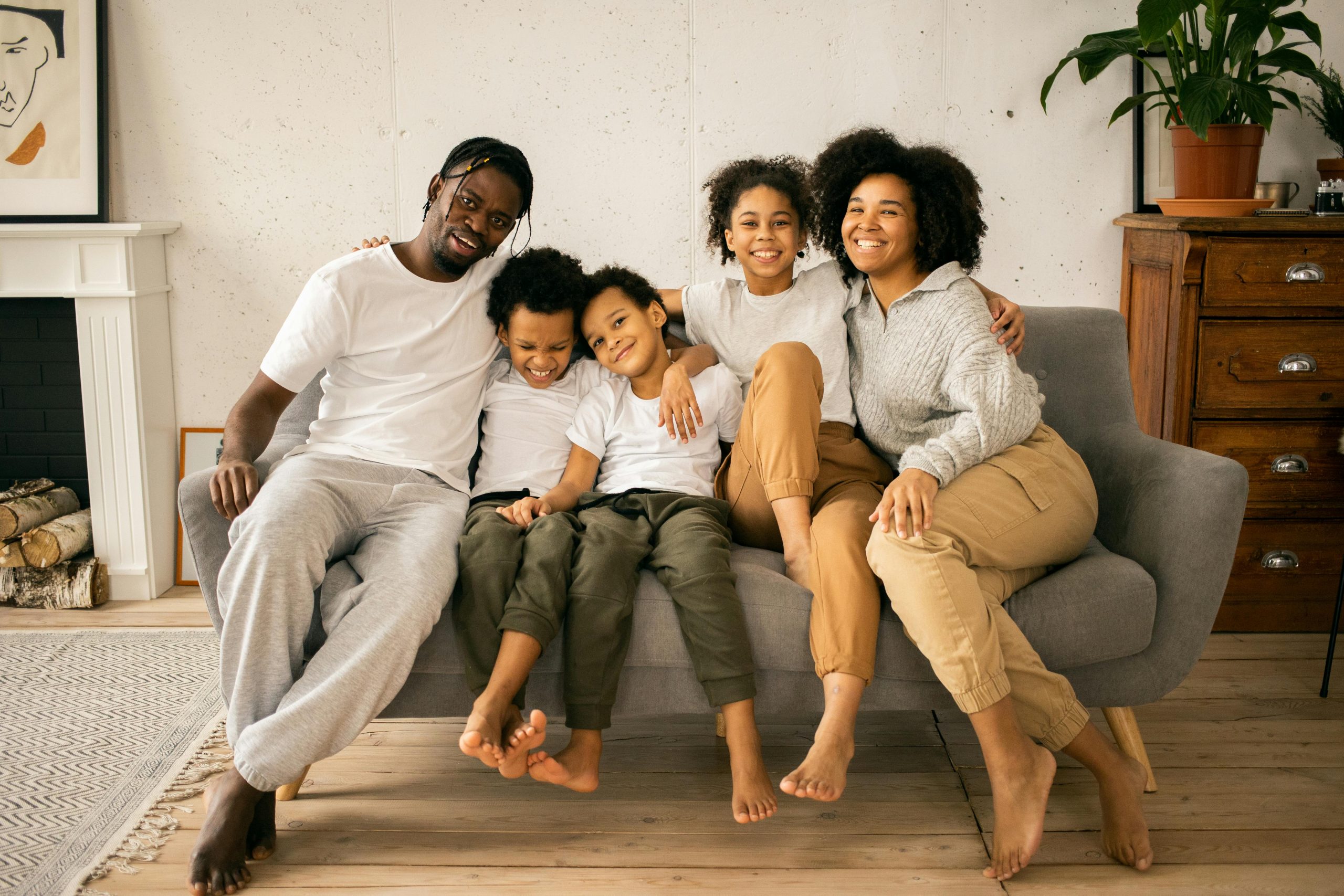 family of 5 seated on a living room couch